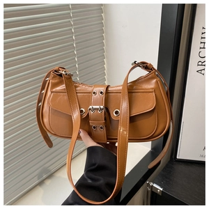 Detailed close-up of brown PU leather shoulder bag with buckle pockets and metal eyelets