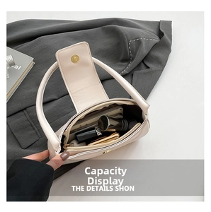 Detail view of large interior capacity of cream white leather half-moon shoulder bag