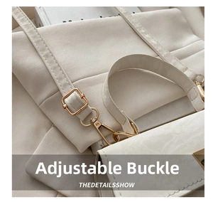 Detail of adjustable pale gold buckle and strap on cream faux leather crossbody bag