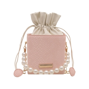 Pink faux snake skin mini drawstring bag with pearl handle and gold chain strap