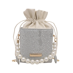 Light grey faux snakeskin mini box bag with large pearl handle and drawstring closure