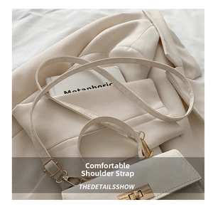 Detail of adjustable strap and metal square buckle on a beige faux leather handbag