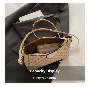 Dettaglio della capacità della borsa a tracolla con motivo floreale e logo moda