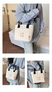 Detail view of cream canvas tote bag featuring cute red bear print and adjustable strap