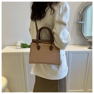 Detail view of the fashion lady handbag with contrast colors and long shoulder strap