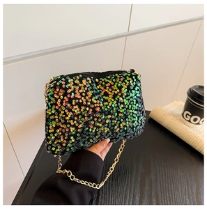 Vue détaillée des paillettes colorées sur le sac noir avec une bandoulière dorée
