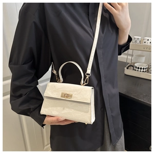 Detailed side view of white marble texture crossbody bag with gold hardware