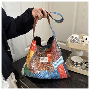 Close-up of ethnic patchwork tote bag with colorful geometric patterns and FASHION label