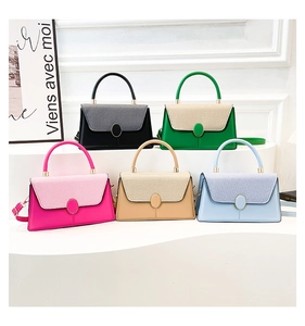 Detail view of colorful cross-body bags with woven texture flap and metallic closure