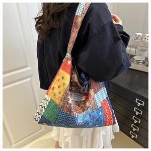 Close-up of ethnic patchwork tote bag with geometric patterns and canvas texture