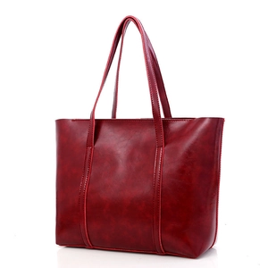 Retro reddish brown oil wax leather tote bag with long shoulder straps on white background