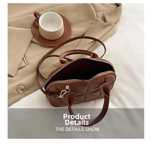 Brown quilted shell handbag placed on a beige blazer with a coffee cup detail