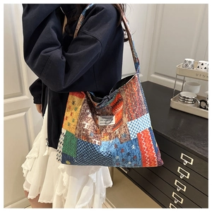 Close-up of ethnic print canvas tote bag with colorful geometric patterns and side view