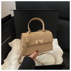 Detail of vintage pleated leather crossbody bag with gold twist lock in a gift box