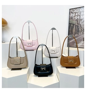 Detailed row of five leather shoulder bags in assorted colors with gold bow buckles