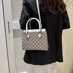 Retro large capacity tote bag with brown geometric pattern and white leather straps