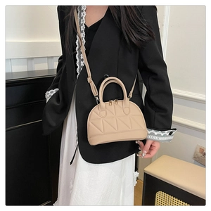 Beige quilted leather crossbody bag with double zippers and elegant embroidery detail