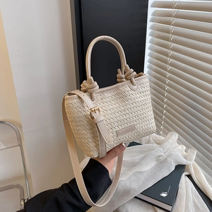 Pastoral straw bucket bag with contrast faux leather handles and adjustable shoulder strap