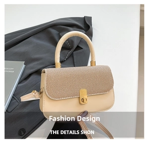 Detail showing contrast woven texture and gold metal clasp on a small square handbag