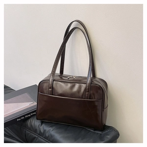 Detailed view of glossy dark brown oil wax leather tote bag with large capacity and straps