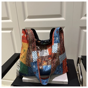 Close-up of patchwork tote bag featuring ethnic patterns and black drawstring details