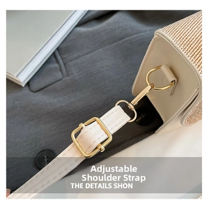 Detail view of adjustable white leather strap with polished gold-tone metal hardware
