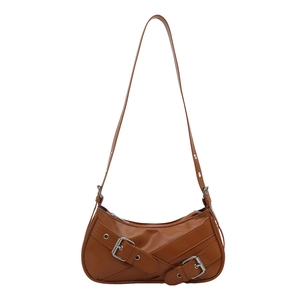 Brown faux leather baguette shoulder bag featuring decorative criss-cross double straps