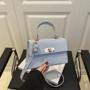 Light blue crossbody handbag with unique paper texture and gold hardware for daily wear