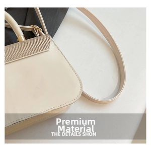 Detail view of beige square bag featuring woven flap and polished synthetic leather texture