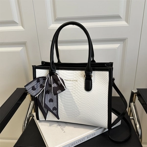 Chic snakeskin embossed tote bag with black handles and a heart pattern silk scarf detail