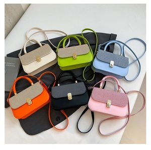 Flat lay of mini crossbody bags in six vibrant colors with metallic woven flaps