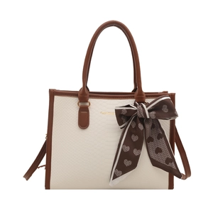 Chic cream faux snake leather tote bag with brown trim and heart print scarf accent