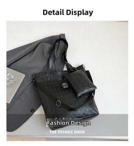 Detail of black skull embossed tote bag with silver crystal skull accent and matching pouch