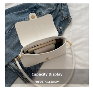 Top view of white leather shoulder bag interior showing capacity for phone and wallet