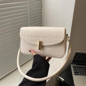 Chic beige crocodile pattern handbag with elegant gold clasp and sturdy handle
