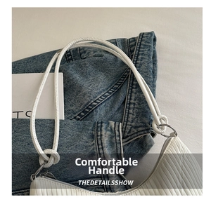 Detail of white striped tote bag showing fine pleated texture and knotted rope shoulder strap