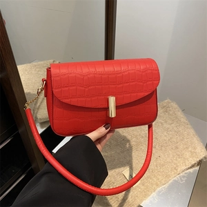 Vintage red crocodile pattern shoulder bag with a stylish gold clasp in a hand-held view