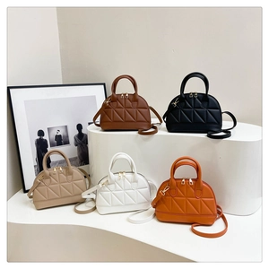 Quilted shell handbags display in five colors with top handles and golden zippers