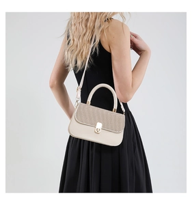 Detail view of cream leather crossbody bag with champagne gold woven texture and metal lock