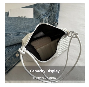 Internal view showing large capacity of the white pleated shoulder bag for daily items