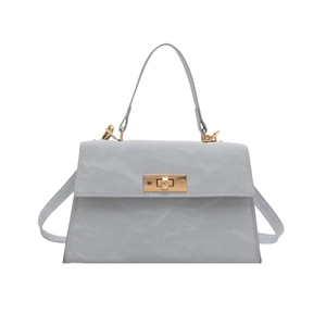 Light blue faux leather trapezoid handbag with gold rotary lock and crossbody strap