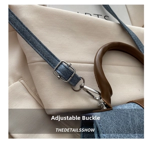 Detail of adjustable silver metal buckle on denim shoulder strap and leather handle