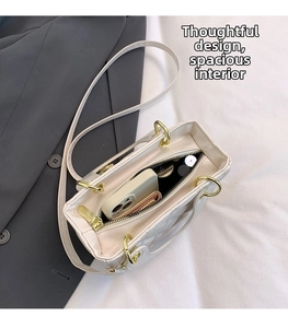 Interior view of white quilted crossbody bag showing storage for phone and makeup