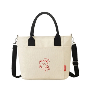 Minimalist canvas tote bag with contrast handles and cartoon bear design in off-white