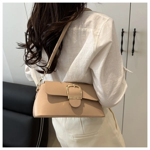 Minimalist beige shoulder bag with gold buckle detail shown worn on a female model