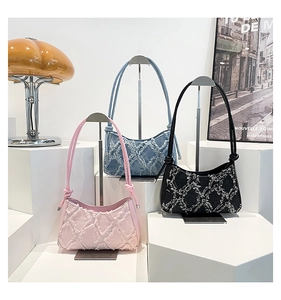 Three denim underarm bags with frayed diamond patterns in pink, blue, and black