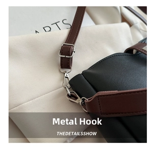 Detailed macro view of high-quality silver metal hardware hook on a stylish bucket bag