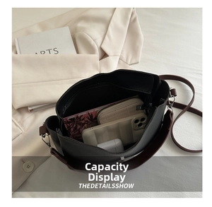 Spacious interior of black PU crossbody bag showing compartments for phone and wallet