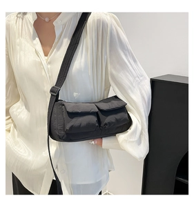 Close-up of black nylon crossbody bag with dual cargo pockets and adjustable strap