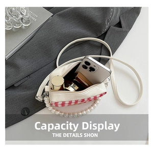 Interior view showing the large capacity for smartphone and makeup in a checkered bag